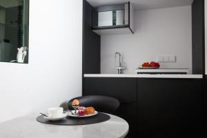 a kitchen with a table with a plate of food on it at Boutique Hotel K7 in Bad Nauheim