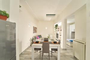 a white dining room with a table and chairs at Casetta Bea in Celle sul Rigo