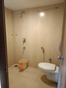 a small bathroom with a toilet and a shower at Hotel A P in Coimbatore