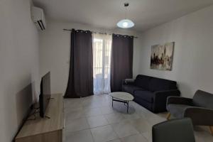 a living room with a couch and a table at Brand new 3 bedroom Apartment close to the sea in Il-Gżira