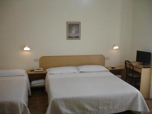 Postel nebo postele na pokoji v ubytování Hotel La Rusticana