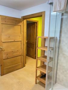 a room with a wooden door and a glass shelf at Apartamentos Playa Galizano in Galizano