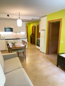 a living room and kitchen with a couch and a table at Apartamentos Playa Galizano in Galizano