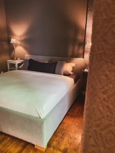 a bedroom with a large bed with white sheets at Ring Residenz by E&P Concept in Adenau