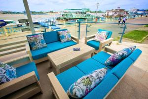 a deck with blue couches and a table with pillows at Hotel Delta 4 in Tulcea