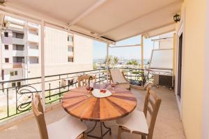a table and chairs on the balcony of a apartment at Prokimea Seaview Apartments in Lefkada