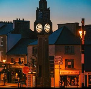 a clock tower in the middle of a city at Country Lane Homestay in Westport