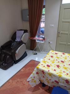 a room with a bed and a chair and a table at Desa Besut Inn in Kuala Besut
