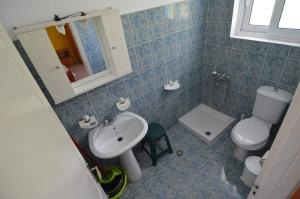 a bathroom with a toilet and a sink at Marianthi Studios Stegna in Archangelos