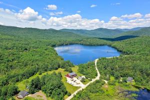 an aerial view of a lake in the mountains at Mountain Meadows Lodge in Killington