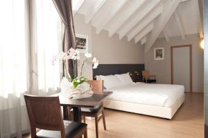 Postel nebo postele na pokoji v ubytování Hotel Osteria della Pista dal 1875