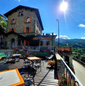 a building with tables and chairs on a balcony at Hotel Bellavista in Abetone