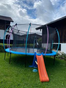 a playground with a slide and a trampoline at Reithamer Bergfensterl in Warngau