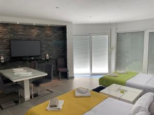 a bedroom with two beds and a desk and a tv at Villa la vie in Ulcinj