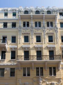 a building with a balcony on the side of it at Trieste 411 - Rooms & Apartments in Trieste