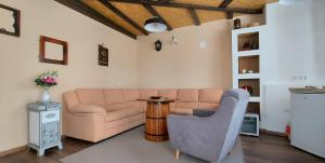 a living room with a couch and a table at Apartments Kapetanovina in Mostar