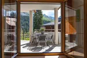 a glass door leading to a patio with a table and chairs at Valletta in Arosa