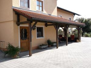 awning on the side of a building with a patio at Appartementhaus Panny in Bad Füssing