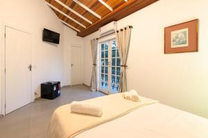 Postel nebo postele na pokoji v ubytování Pousada Portal de Paraty- COM GERADOR DE ENERGIA