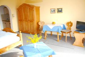 a room with a bedroom with a table and a tv at Appartementhaus Panny in Bad Füssing
