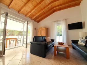 a living room with a couch and a table at Villa Lucija in Rab