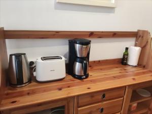 a counter with two coffee makers and a toaster on it at Pensión Atxiki in San Sebastián