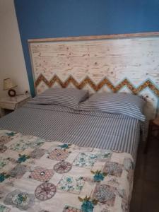 Un pat sau paturi într-o cameră la Casa NonnoNanni
