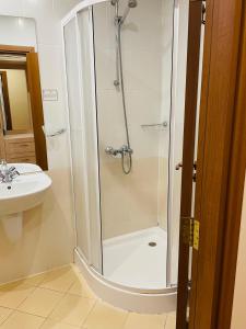 a bathroom with a shower and a sink at Studio Kris Villa Park in Borovets