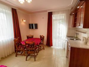 a kitchen with a table and chairs in a room at Solar Apartmanok in Hajdúszoboszló
