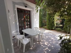 a white table and chairs on a patio at Kastély in Hajdúszoboszló