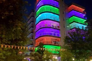 a building with colorful lights on it at night at Carmen Suite Hotel in Alanya
