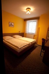 Postel nebo postele na pokoji v ubytování Hotel U Jiřího