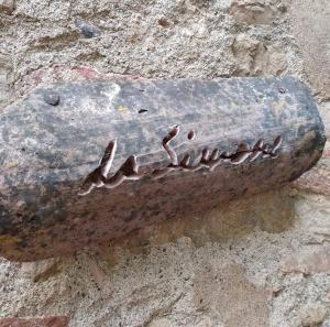 a metal object on the side of a stone wall at Da Simone podere santi Lucia e Pietro in Siena
