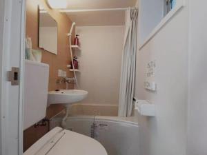 a small bathroom with a toilet and a sink at YUYU-Yo-3 --Self Check-in -- Room Number & Password is in the following email in Tokyo