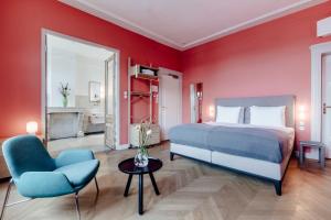 a bedroom with a bed and a chair and a table at Maison Haas Hustinx & Spa in Maastricht +54 photos
