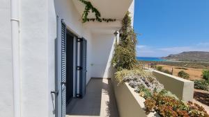 a door to a house with a view of the ocean at Domatia me Thea in Elafonisos