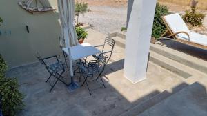a table and chairs sitting on a patio at Domatia me Thea in Elafonisos