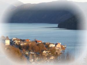 a town on the shore of a large body of water at Haus Harmonie in Millstatt