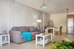 a living room with a couch and two tables at Apartment Lilly, brand new apartment with communal pool, 10 meters from sea in Sami