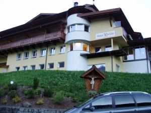 a building with a car parked in front of it at Hotel Bruno in Sölden