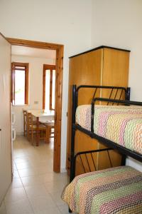 a room with two bunk beds and a dining room at Residence Villa Agrimare in Vieste
