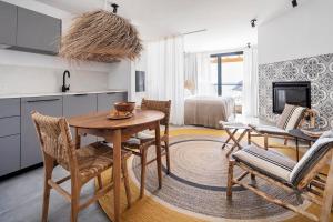 a kitchen and dining room with a table and chairs at Casas da Praia by Sevencollection in Salema