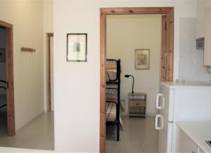 a kitchen with a door open to a kitchen with a refrigerator at Residence Villa Agrimare in Vieste