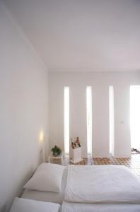 two beds in a bedroom with white walls at Unique Architect's House in Essaouira +45 photos