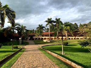 um pátio com palmeiras e um edifício em Polo Hotel Fazenda em Indaiatuba