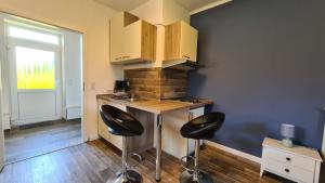 a kitchen with a counter and two stools in a room at 12 Mohnblume in Parchtitz