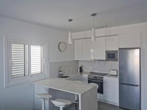 A kitchen or kitchenette at Luxury Apartment On The Beach