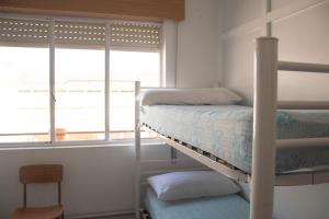 A bunk bed or bunk beds in a room at Albergue Santa Olaia