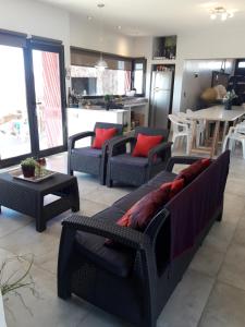 a living room with several couches and a table at sueño del chocon in Villa El Chocón