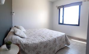 a bedroom with a bed with a teddy bear on it at sueño del chocon in Villa El Chocón